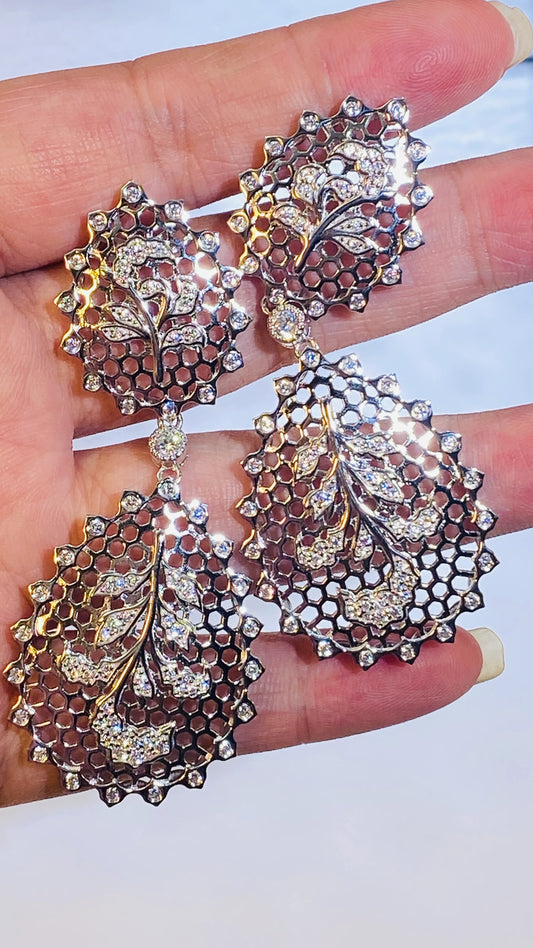 These large, hollowed-out leaf earrings are a masterpiece of design. Inspired by classic Italian jewelry, their teardrop shape is elevated by intricate hand-carved details and sparkling 5A grade zircon accents. The sophisticated white gold plating ensures a luxurious and polished finish, making these a truly statement-making piece for any jewelry collection.