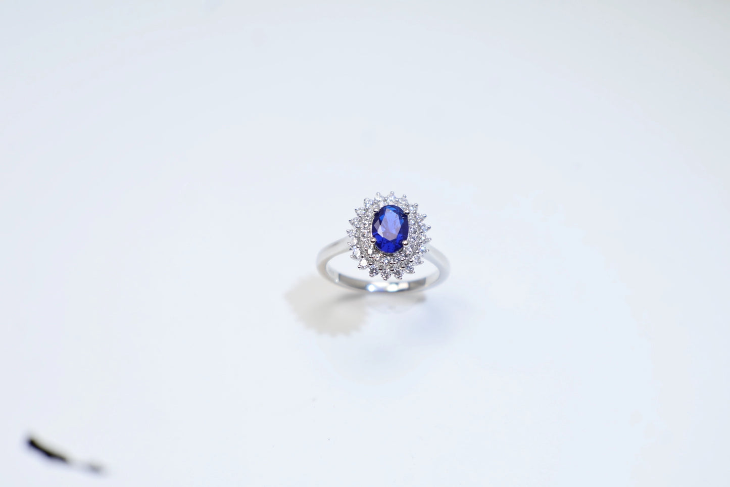 Oval Blue Spinel Halo Engagement Ring in White Gold Plated Silver