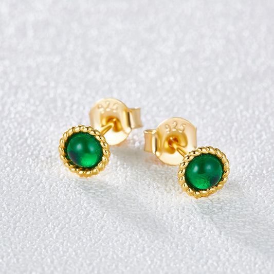 Small emerald stud earrings worn on ear gold plated supplier