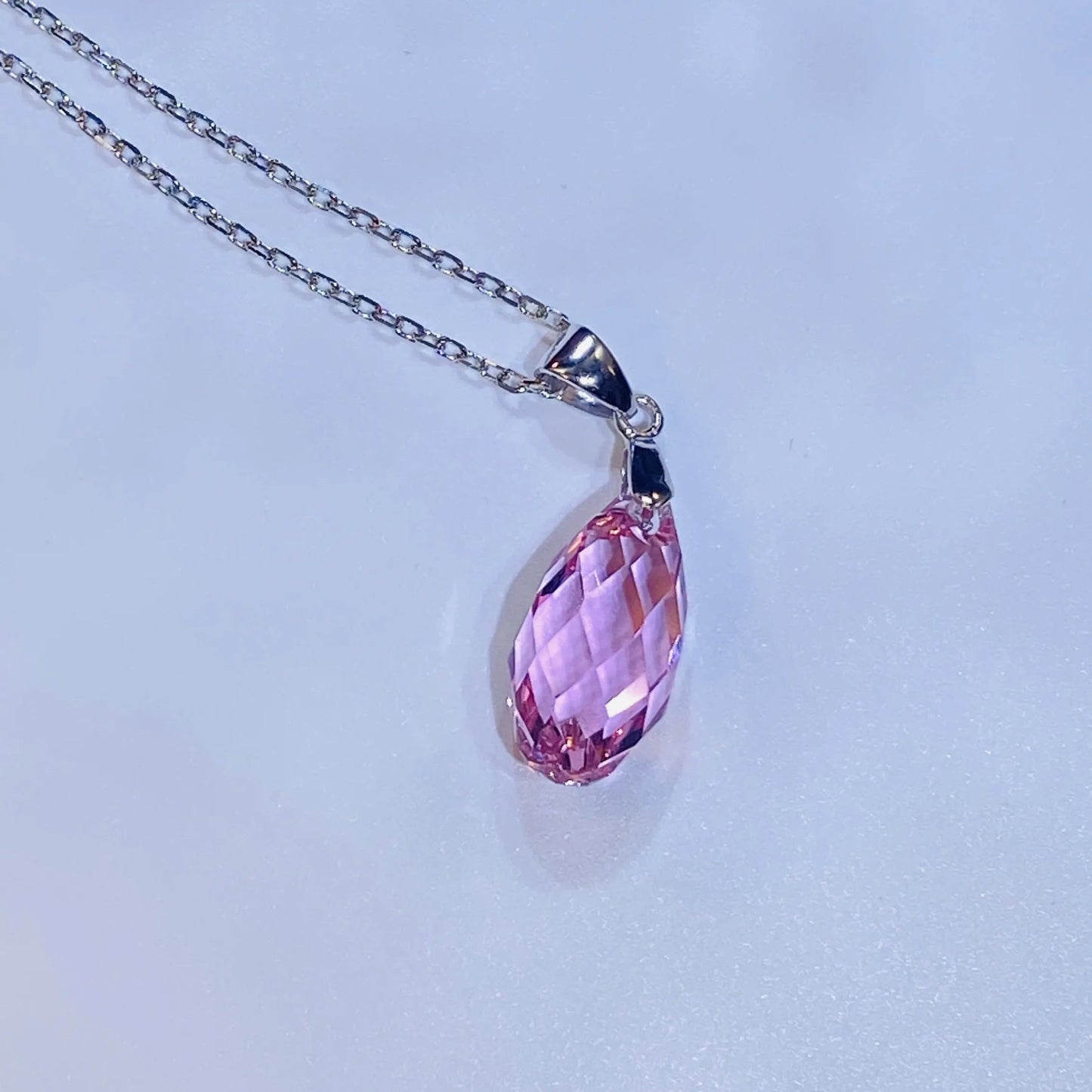 Introduce this elegant teardrop pendant necklace to your collection. It features a premium, precision-cut pink crystal with a stunning clarity and sparkle inspired by top European crystal houses. Crafted from durable 925 sterling silver, this piece offers a sophisticated, luxurious aesthetic. A high-quality, fashionable choice for B2B buyers seeking timeless yet on-trend accessories.