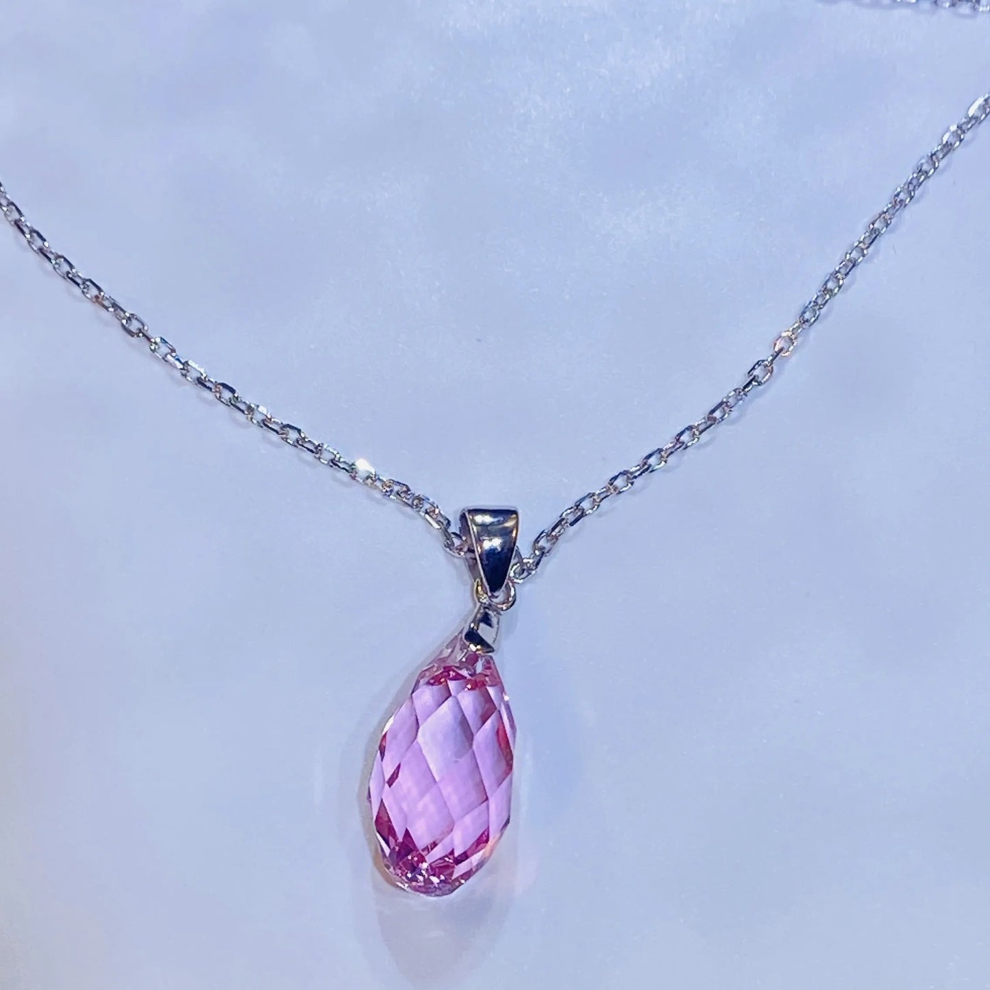 Introduce this elegant teardrop pendant necklace to your collection. It features a premium, precision-cut pink crystal with a stunning clarity and sparkle inspired by top European crystal houses. Crafted from durable 925 sterling silver, this piece offers a sophisticated, luxurious aesthetic. A high-quality, fashionable choice for B2B buyers seeking timeless yet on-trend accessories.
