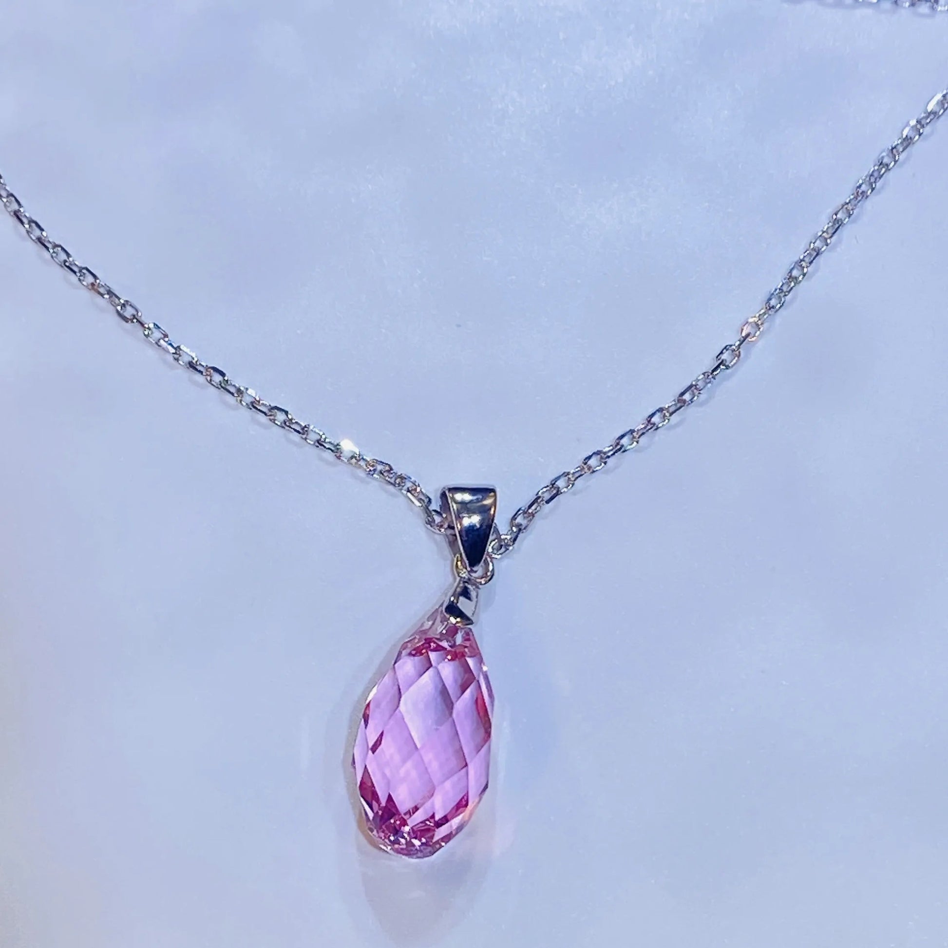 Introduce this elegant teardrop pendant necklace to your collection. It features a premium, precision-cut pink crystal with a stunning clarity and sparkle inspired by top European crystal houses. Crafted from durable 925 sterling silver, this piece offers a sophisticated, luxurious aesthetic. A high-quality, fashionable choice for B2B buyers seeking timeless yet on-trend accessories.