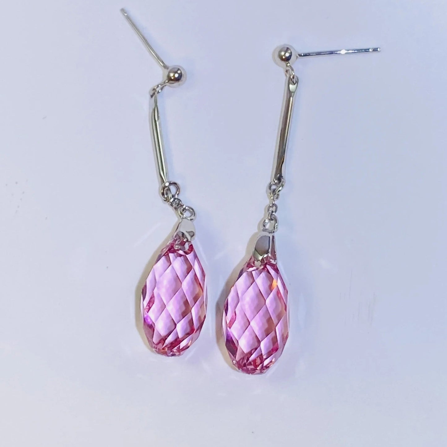 Introduce these elegant teardrop dangle earrings to your collection. They feature premium, precision-cut pink crystals with a stunning clarity and sparkle inspired by top European crystal houses. Crafted from durable 925 sterling silver, these earrings offer a sophisticated, luxurious aesthetic. A high-quality, fashionable choice for B2B buyers seeking timeless yet on-trend accessories.