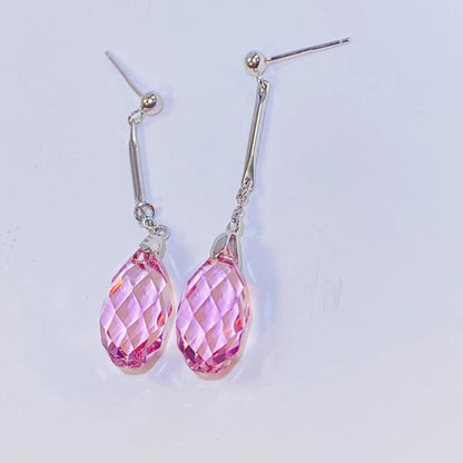 Introduce these elegant teardrop dangle earrings to your collection. They feature premium, precision-cut pink crystals with a stunning clarity and sparkle inspired by top European crystal houses. Crafted from durable 925 sterling silver, these earrings offer a sophisticated, luxurious aesthetic. A high-quality, fashionable choice for B2B buyers seeking timeless yet on-trend accessories.