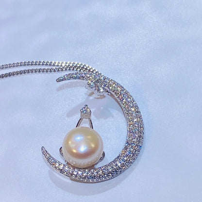 This unique moon-shaped necklace is meticulously handcrafted from sterling silver and set with hundreds of micro-zircon stones for a stunning, sparkling effect. A natural freshwater pearl rests elegantly on the moon's curve, adding a touch of classic sophistication to this modern design. The piece is finished with a luxurious 18K gold plating, making it a versatile and captivating addition to any collection.