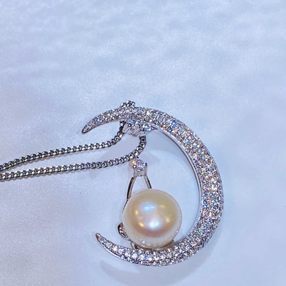 This unique moon-shaped necklace is meticulously handcrafted from sterling silver and set with hundreds of micro-zircon stones for a stunning, sparkling effect. A natural freshwater pearl rests elegantly on the moon's curve, adding a touch of classic sophistication to this modern design. The piece is finished with a luxurious 18K gold plating, making it a versatile and captivating addition to any collection.
