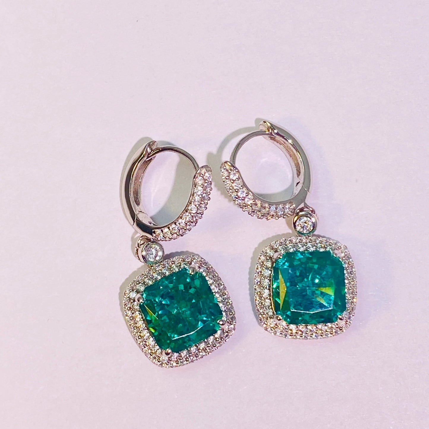 Imported Paraiba 8*8mm hand-cut 5A-grade high-carbon diamonds are used to create a dazzling, translucent look. The ear hook connection is flexible and dynamic, making it suitable for women. The entire piece is made of 925 sterling silver with four layers of gold plating, which is anti-oxidation and non-allergenic.