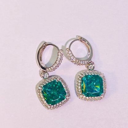 Imported Paraiba 8*8mm hand-cut 5A-grade high-carbon diamonds are used to create a dazzling, translucent look. The ear hook connection is flexible and dynamic, making it suitable for women. The entire piece is made of 925 sterling silver with four layers of gold plating, which is anti-oxidation and non-allergenic.