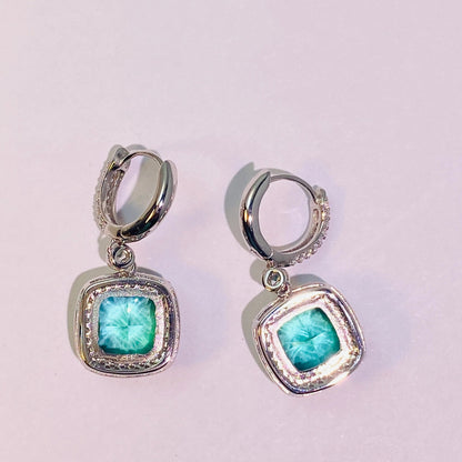 Imported Paraiba 8*8mm hand-cut 5A-grade high-carbon diamonds are used to create a dazzling, translucent look. The ear hook connection is flexible and dynamic, making it suitable for women. The entire piece is made of 925 sterling silver with four layers of gold plating, which is anti-oxidation and non-allergenic.