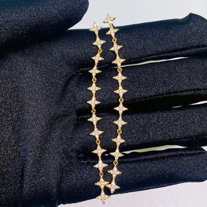 These exquisite, long star chain dangle earrings are crafted with 5A grade imported zircon and feature a thick 1.0um champagne gold plating. Our advanced silver-to-K gold plating process achieves the luxury look and feel of fine gold jewelry, perfect for discerning B2B buyers seeking high-quality, fashion-forward pieces.