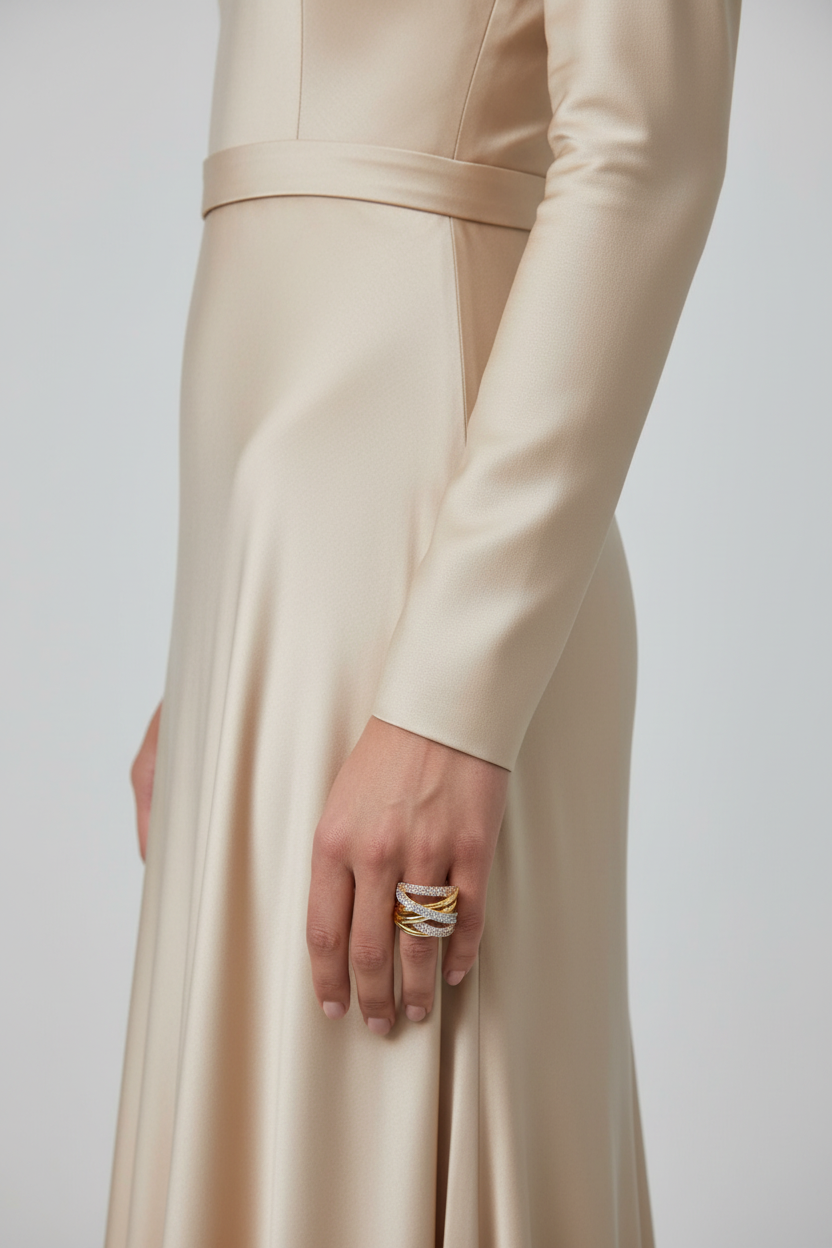 Model hand wearing tri-color gold crossover wave pavé CZ wide band ring, luxury jewelry editorial