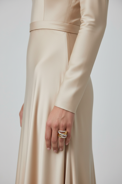 Model hand wearing tri-color gold crossover wave pavé CZ wide band ring, luxury jewelry editorial