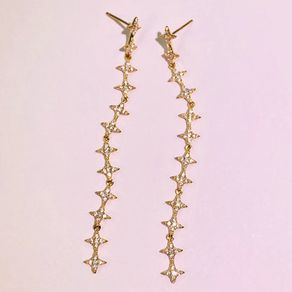 These exquisite, long star chain dangle earrings are crafted with 5A grade imported zircon and feature a thick 1.0um champagne gold plating. Our advanced silver-to-K gold plating process achieves the luxury look and feel of fine gold jewelry, perfect for discerning B2B buyers seeking high-quality, fashion-forward pieces.