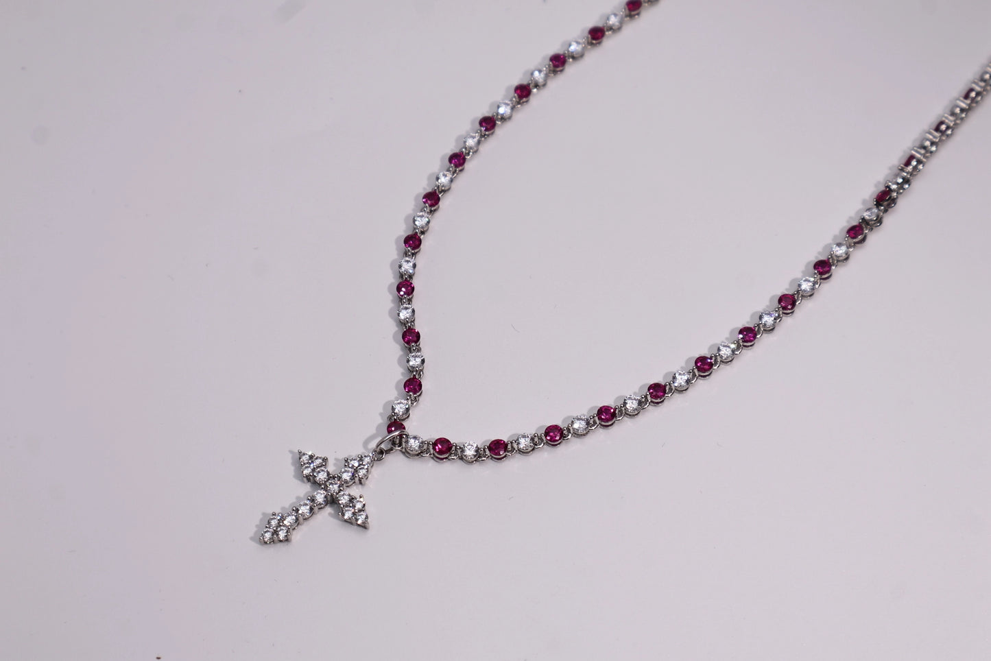 necklace with a full diamond chain and a cross.