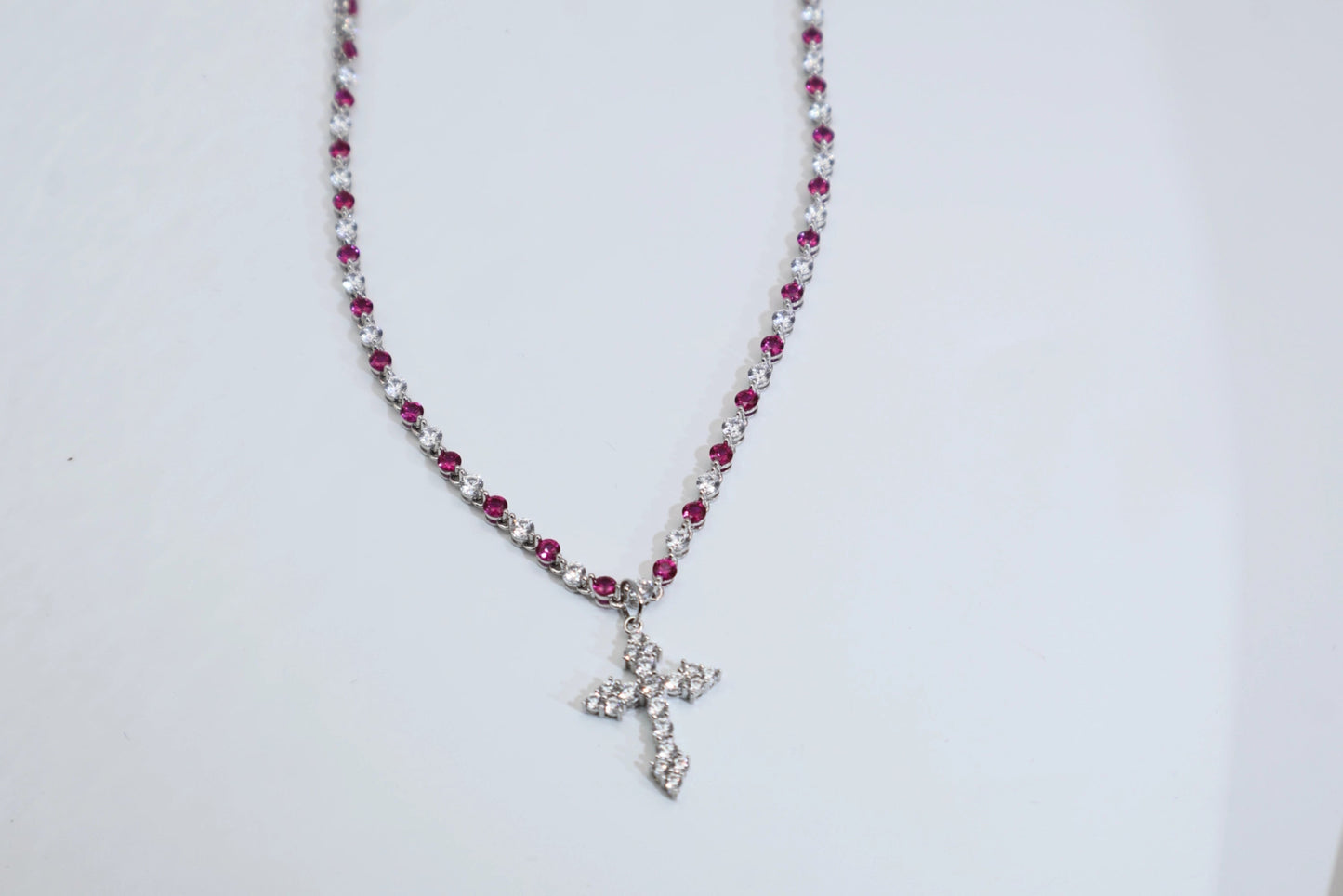 necklace with a full diamond chain and a cross.