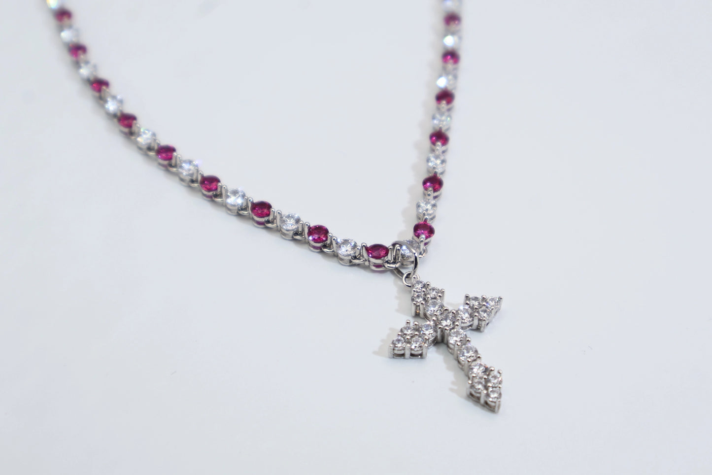 necklace with a full diamond chain and a cross.