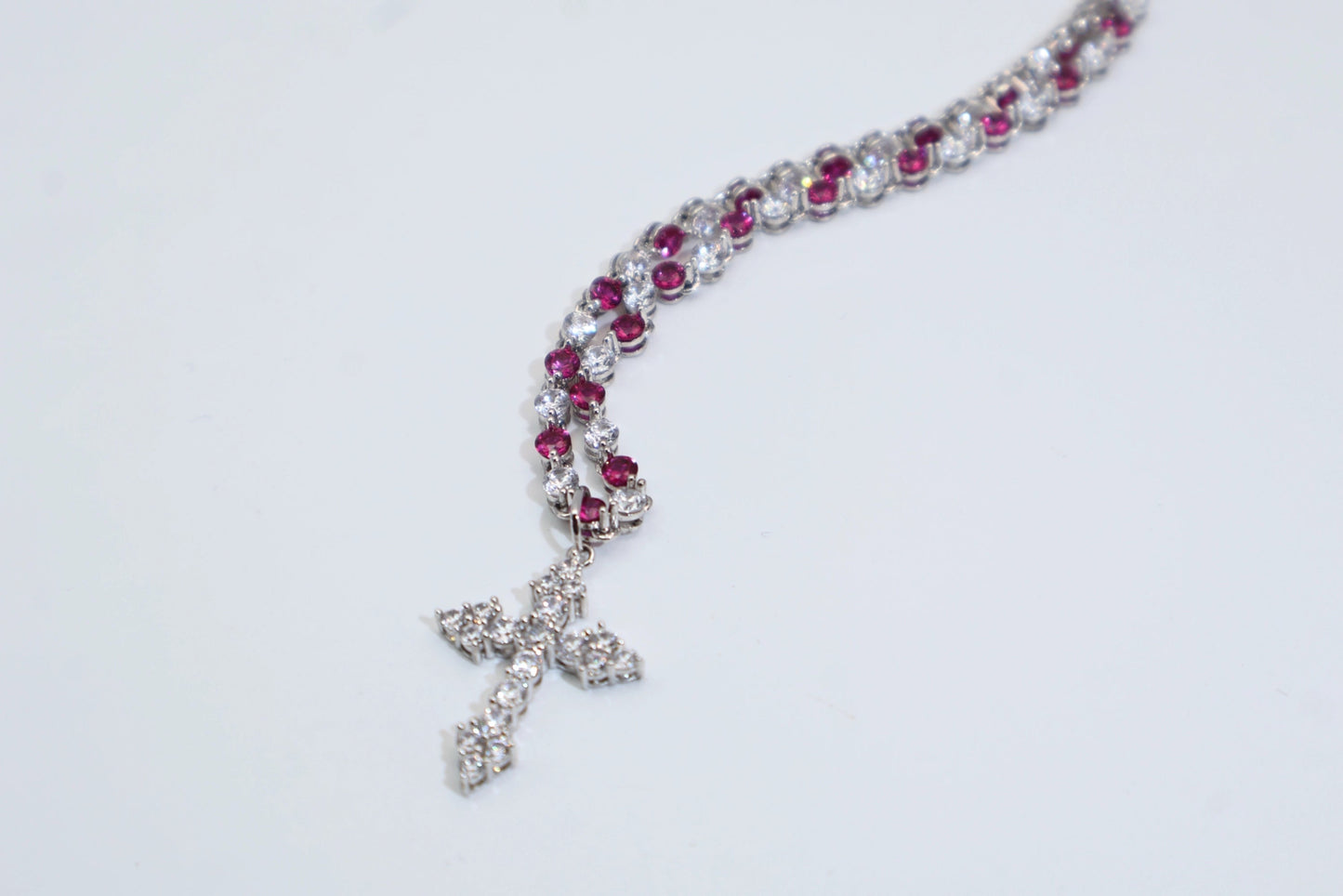 necklace with a full diamond chain and a cross.